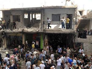 A handout picture released by the Syrian Arab News Agency (SANA) on June 23, 2013, shows civilians and security at the scene of a bombing in Damascus (SANA / AFP)