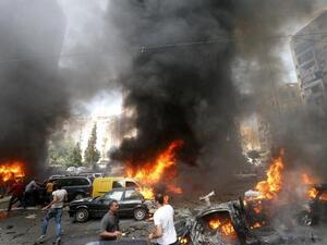 Civilians gather at the of an explosion in Beirut's southern suburb neighbourhood of Bir al-Abed on July 9 (AFP)