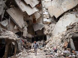 A man walks amid destruction in Aleppo, Syria (AFP/ Dimitar Dilkoff)