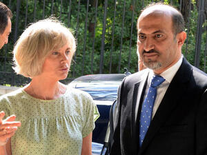 FRANCE, Paris : Syria's new opposition chief Ahmad Jarba is welcomed by Elisabeth Guigou, head of the French national assembly Foreign Affairs commitee, before his hearing on July 23, 2013 on the fisrt of a two-day visit aimed at convincing France to boost its support for rebels battling Syrian President. AFP PHOTO / PHOTO PIERRE ANDRIEU
