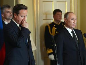 British Prime Minister David Cameron  and Russian President Vladimir Putin in London on Sunday, where they discussed the latest developments in Syria.(AFP PHOTO/POOL/ANTHONY DEVLIN)