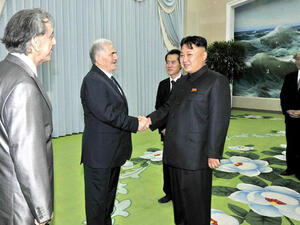 This picture, taken by North Korea's official Korean Central News Agency on July 24, 2013 shows North Korean leader Kim Jong-Un shaking hands with Abdullah al-Ahmar, deputy general secretary of the Syria's Baath Arab Socialist Party in Pyongyang.  "AFP PHOTO / KCNA VIA KNS" 
