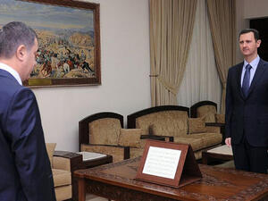 A handout picture released by the Syrian Arab News Agency (SANA) shows Syrian President Bashar al-Assad  with the newly-appointed governor of Syria's province of Quneitra Maen Salah-Eddin Ali, after he was sworn in on July 18, 2013. (AFP PHOTO / HO / SANA)