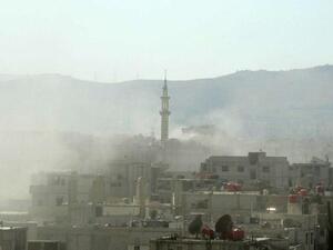 A handout image released by the Syrian opposition's Shaam News Network shows smoke above buildings following what Syrian rebels claim to be a toxic gas attack by pro-government forces in eastern Ghouta, on the outskirts of Damascus on August 21, 2013. "AFP PHOTO / HO / SHAAM NEWS NETWORK" 
