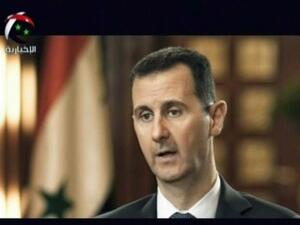 Syrian President Bashar al-Assad gives an interview to a Syrian state news channel (AFP)