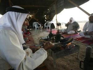 Bedouin men enjoy one another's company over traditional Arabic coffee in their tent in Israel's Negev desert. (AFP/File)