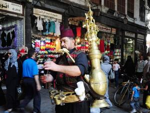 A man sells traditional drinks on the streets of central Damascus.  (AFP/File)