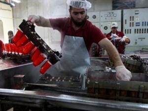 Workers make ice cream at a factor in Khan Younis, a city in the Gaza Strip. (AFP/Said Khatib)