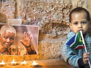 Members of the African-Palestinian community in Jerusalem's Old City attend a ceremony commemorating South African leader Nelson Mandela.  Many have likened Mandela's fight against apartheid to Palestinians' struggle against Israeli occupation.  (AFP/File)