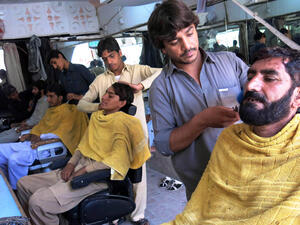 Men get their beards trimmed at a barber shop in Pakistan, July 2014.  (AFP/File)