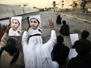Bahraini demonstrators hold up photos of detained Shiite cleric and opposition leader Sheikh Ali Salman in a suburb of the capital Manama.  (AFP/Mohammed al-Shaikh)