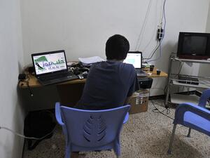A young Syrian man works on his laptop in Aleppo.  (AFP/Tauseef Mustafa)