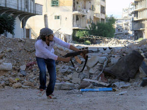 A rebel fires a gun in Syria. Women have appeared on Syrian television saying they were kidnapped by rebel forces for “sexual jihad.” (Image credit: AFP)