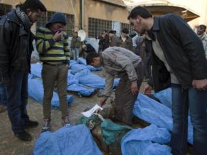 مواطنون سوريون يبحثون عن اقارب ومعارف لهم بين جثث مدنيين قتلوا والقي بهم في نهر قويق/أ.ف.ب