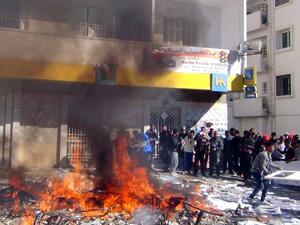 Tunisians protestors set fire to documents and belongings of the country's ruling Islamist Ennahda party's outside their headquarters in the central Tunisian town of Gafsa on November 27, 2013. [AFP]