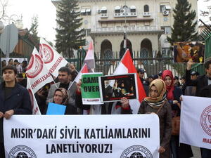 Ousted Egyptian President Morsi's supporters demonstrate against the current Egyptian government in front of the Egyptian embassy in Ankara on November 22, 2013. 