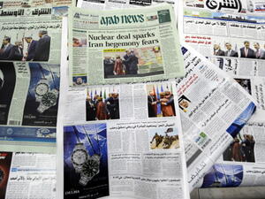 Saudi newspapers headlining the deal made with major powers over Iran's disputed nuclear deal are seen on November 25, 2013 in the capital Riyadh. [AFP]