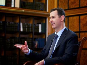 SYRIA, DAMASCUS : A handout picture released by the official Syrian Arab News Agency (SANA) on September 12, 2013, shows President Bashar al-Assad attending an interview with Russian television [AFP]