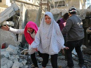 Syrian girls react following a reported Syrian regime air strike in a rebel-controlled area in the northern city of Aleppo on February 8, 2016. (AFP/Ameer al-Halbi)