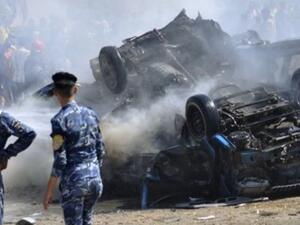 Iraqi security forces stand at the site of a bomb attack. [presstv.ir]