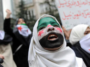 A young woman with her face painted with the Syrian flag attends a demonstration against Syrian President Bashar al-Assad in front of the Syrian Consulate on December 16, 2011 in Istanbul. (AFP/Bulent Kilic)