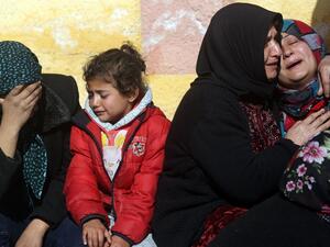 Relatives of a Kurdish herder mourn outside the hospital in Afrin on January 28, 2018, after he was killed in a Turkish airstrike on their village near the Kurdish enclave (Delil Souleiman/AFP)