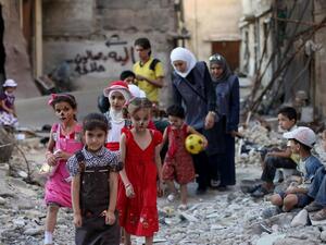 Syrian children walk amid destruction on the outskirts of Damascus in Eid Al Fitr. (Amer Al Mohibany/ AFP)