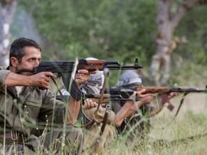 PKK fighters take position with their rife during a traning session. (AFP)