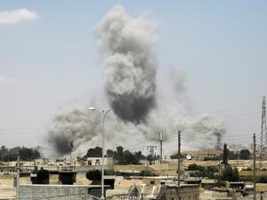 Smoke billows from buildings in the northern Syrian city of Raqa on June 18, 2017, during an offensive by US-backed fighters to retake the Islamic State (IS) group bastion. (Delil Souleiman/AFP)