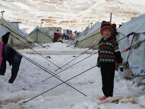A Syrian child stands in the snow in a camp in Lebanon's Bekaa Valley (AFP / File)