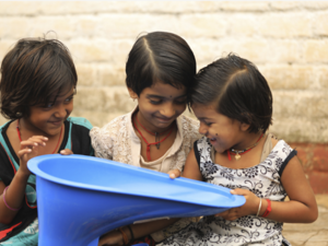 Three girls in India holding a SATO product. Credit ©LIXIL.