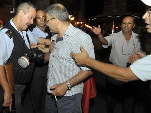TUNISIA, Tunis : A Tunisian protestor clashes with police in front of the interior ministry headquarters in Tunis following the assassination of leading opposition figure Mohamed Brahmi late on July 25, 2013.