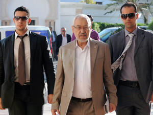 Tunisia's ruling Islamist Ennahda party's leader Rached Ghannouchi (C) arrives for a meeting as part of talks with the opposition. (Image credit: AFP)