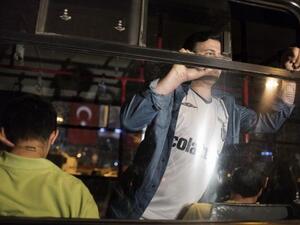 Men detained for emulating Turkish choreographer Erdem Gunduz for standing on Taksim square in a lone protest are seen arrested inside a truck used by the Turkish police June 18 (Marco Longari / AFP)
