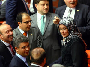 Turkey's ruling Justice and Development Party (AKP) MP Gulay Samanci (R) is greeted as she attends a general assembly meeting wearing a headscarf at the Turkish Parliament in Ankara. (Image credit: AFP)