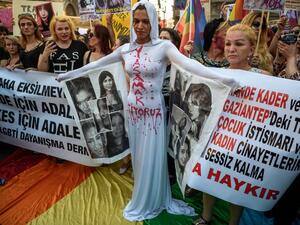 A LGBT protester stands in front of a banner and "We want to live" written on her body on August 21, 2016 in Istanbul during a demonstration against the murder of transgender activist Hande Kader.. (AFP/Ozan Kose) A LGBT protester stands in front of a banner and "We want to live" written on her body on August 21, 2016 in Istanbul during a demonstration against the murder of transgender activist Hande Kader.. (AFP/Ozan Kose)