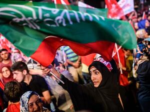 A woman waves flags during a pro-Erdogan rally in Taksim square in Istanbul on July 22, 2016, following the failed military coup attempt of July 15. (AFP/Ozan Kose) A woman waves flags during a pro-Erdogan rally in Taksim square in Istanbul on July 22, 2016, following the failed military coup attempt of July 15. (AFP/Ozan Kose)