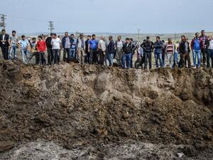 People look in a huge crater after a powerful blast on May 13, 2016 in the area of Sarikamis on the outskirts of the majority Kurdish city of Diyarbakir. (AFP/Ilyas Akengin) People look in a huge crater after a powerful blast on May 13, 2016 in the area of Sarikamis on the outskirts of the majority Kurdish city of Diyarbakir. (AFP/Ilyas Akengin)