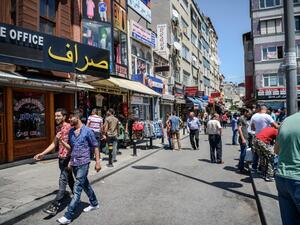 Syrian and Turkish people walk in a street next to shops with Arabic signs on July 4 ,2016 in Fatih neighborhood in Istanbul. (AFP/Ozan Kose) Syrian and Turkish people walk in a street next to shops with Arabic signs on July 4 ,2016 in Fatih neighborhood in Istanbul. (AFP/Ozan Kose)