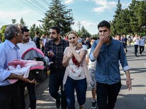 An injured woman, next to a man carrying her baby, walks near the site where a bomb explosed on May 10, 2016 in Diyarbakir. Three people were killed and 22 wounded in the attack. (AFP/Ilyas Akengen) An injured woman, next to a man carrying her baby, walks near the site where a bomb explosed on May 10, 2016 in Diyarbakir. Three people were killed and 22 wounded in the attack. (AFP/Ilyas Akengen)