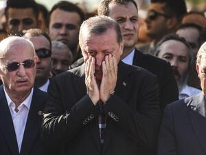 Turkey's President Recep Tayyip Erdogan reacts after attending the funeral of a victim of the coup attempt in Istanbul on July 17, 2016. (AFP/Bulent Kilic) Turkey's President Recep Tayyip Erdogan reacts after attending the funeral of a victim of the coup attempt in Istanbul on July 17, 2016. (AFP/Bulent Kilic)