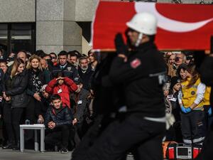 Turkish police officers carry a coffin of a killed police officer as relatives mourn during a funeral ceremony for killed police officers at Istanbul's police headquarters on December 11, 2016. (AFP/Ozan Kose)