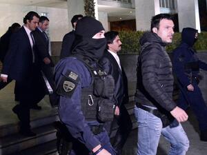 Four out of eight Turkish military officers are escorted by Greek special police forces as they leave the Athens' Supreme Courthouse, after a day-long hearing concerning possible extradition over July's failed coup in Turkey, on January 13, 2017 in Athens. (AFP/Louisa Gouliamaki)