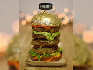 The towering burger is topped with edible 24-carat gold. (Courtesy The Roadery)