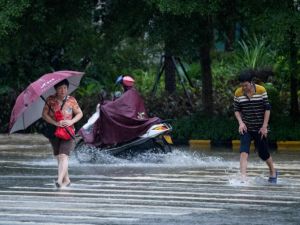 People wade through flooded streets a day after super Typhoon Mangkhut in Yangjiang, in Guangdong province on September 17, 2018. (AFP/ File)