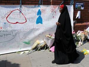 A woman walks past messages attached to a wall near the scene of an attack next to Finsbury Park Mosque, in north London, June 20, 2017. (AFP/ File)