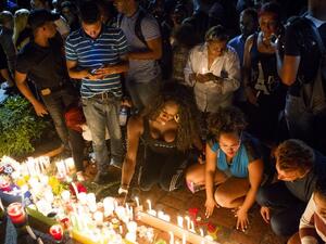 People light candles at a memorial gathering for those killed in Orlando at the Colonial Zone in Santo Domingo on June 14, 2016. (AFP/Erika Santelices)