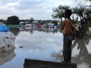 A Somalian internally displaced child looks at a flooded section of a camp in Mogadishu, following heavy rain and flash floods. (AFP/File Photo)