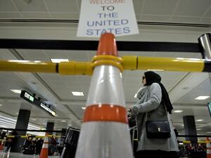 A passenger from a Riyadh, Saudi Arabia inbound flight, arrives at the international arrivals hall at Washington Dulles International Airport February 6, 2017. (AFP/Brendan Smialowski)