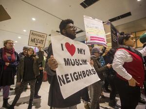 A protestor demonstrates against the new ban on immigration issued by President Donald Trump at Logan International Airport, Boston on January 28, 2017. (AFP/Scott Eisen)